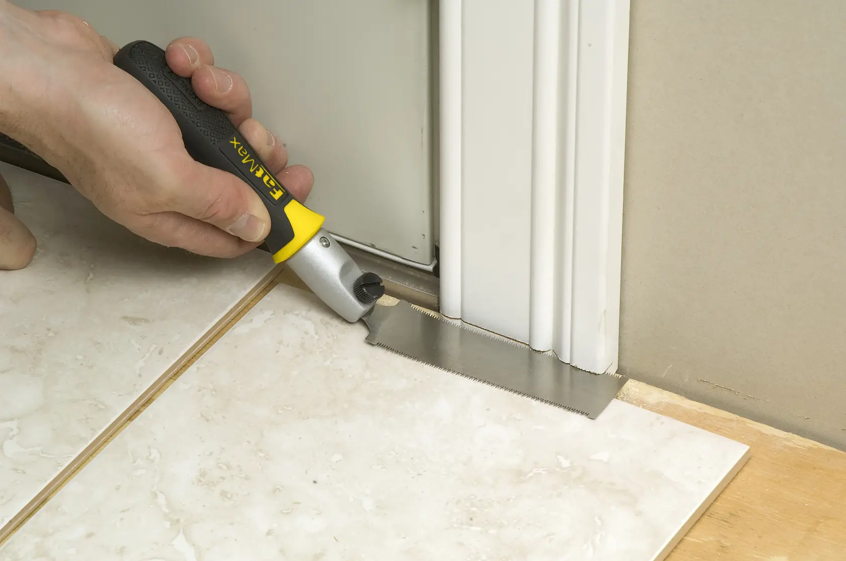 STANLEY 0-20-331 pull saw used to cut door frame at floor level, shown during tile installation.