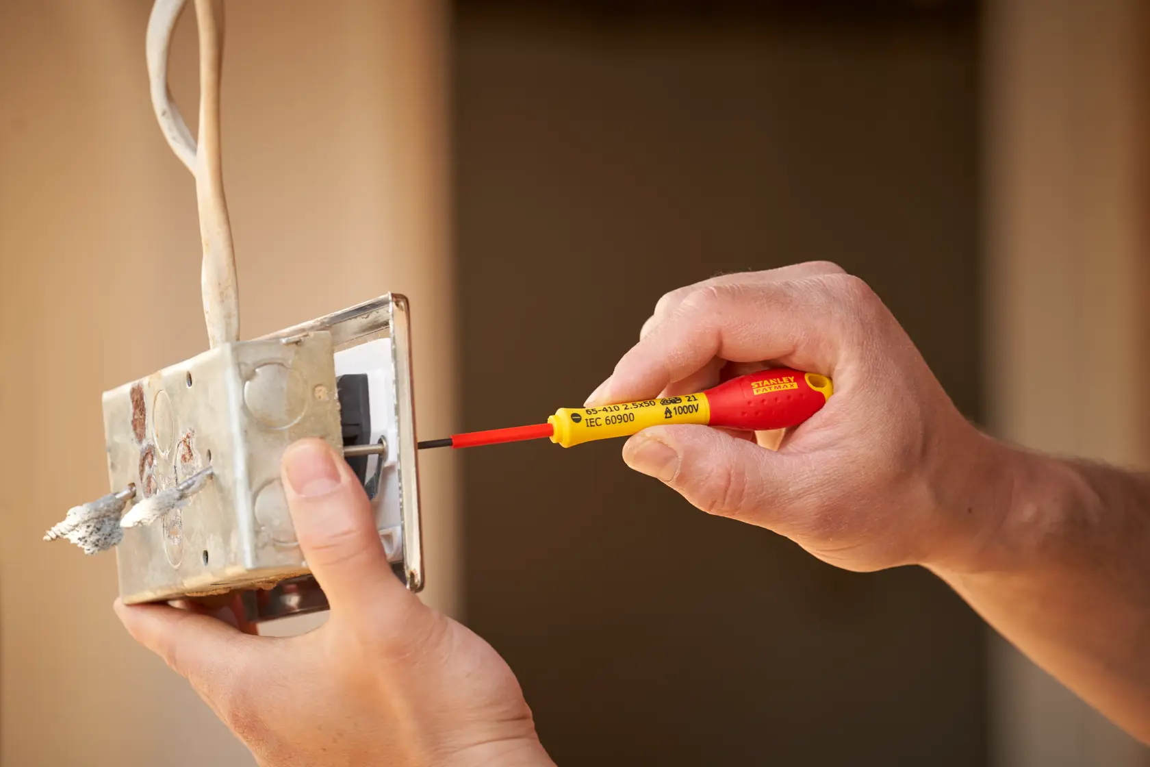 Photo of STANLEY 0-65-410 insulated screwdriver used on electrical junction box.