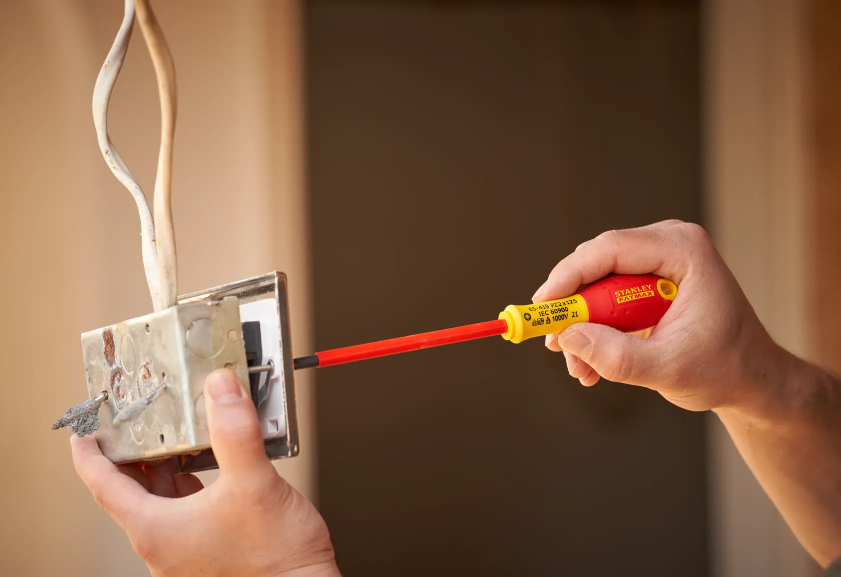 Photo of STANLEY 0-65-419 insulated screwdriver used on an electrical switch box.