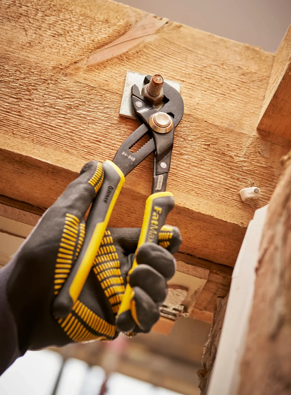 Adjustable grooved joint pliers with black and yellow handles, shown against a white background.