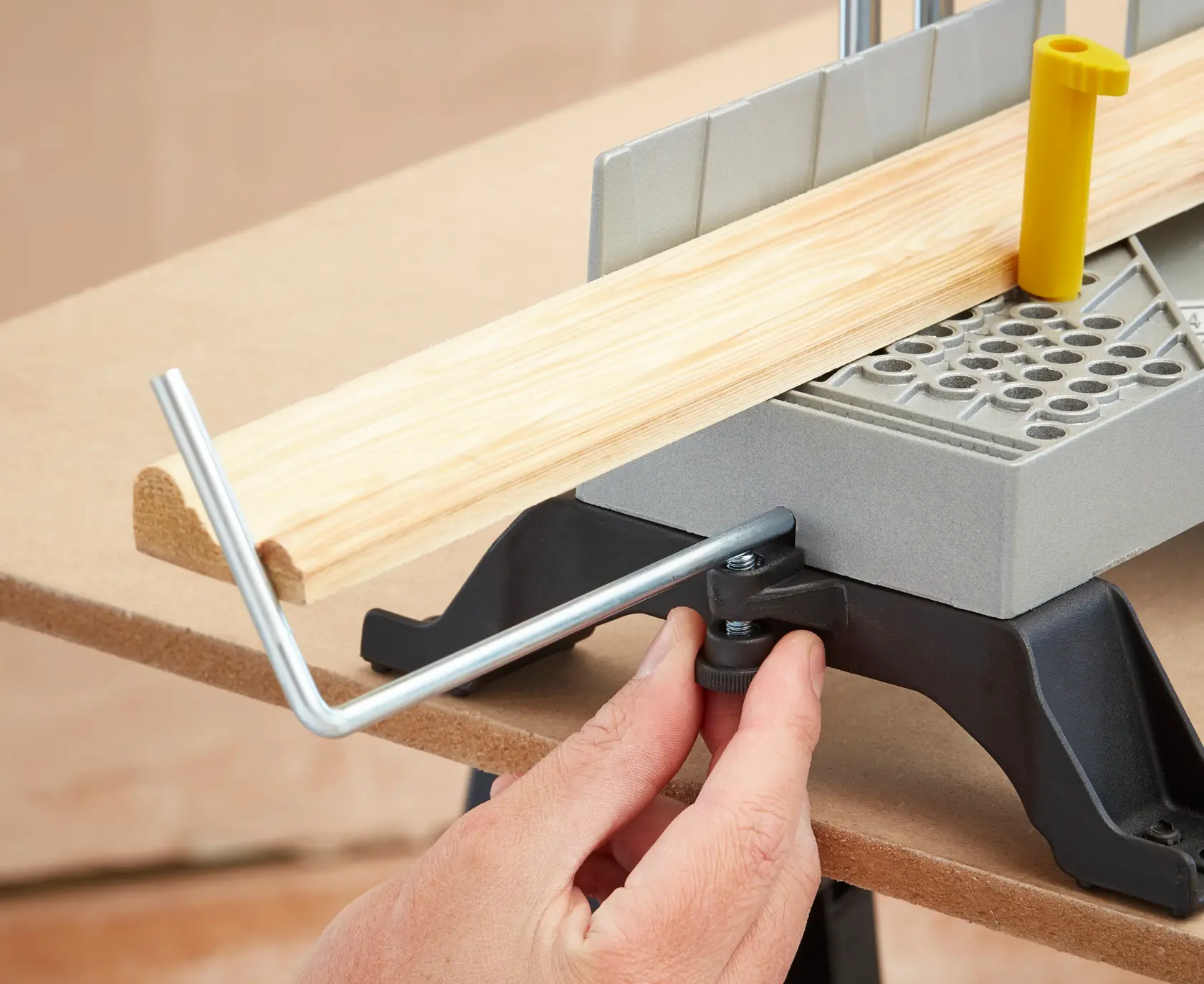 STANLEY 1-20-800 manual mitre saw with yellow handle and adjustable base, front angle, on white background.