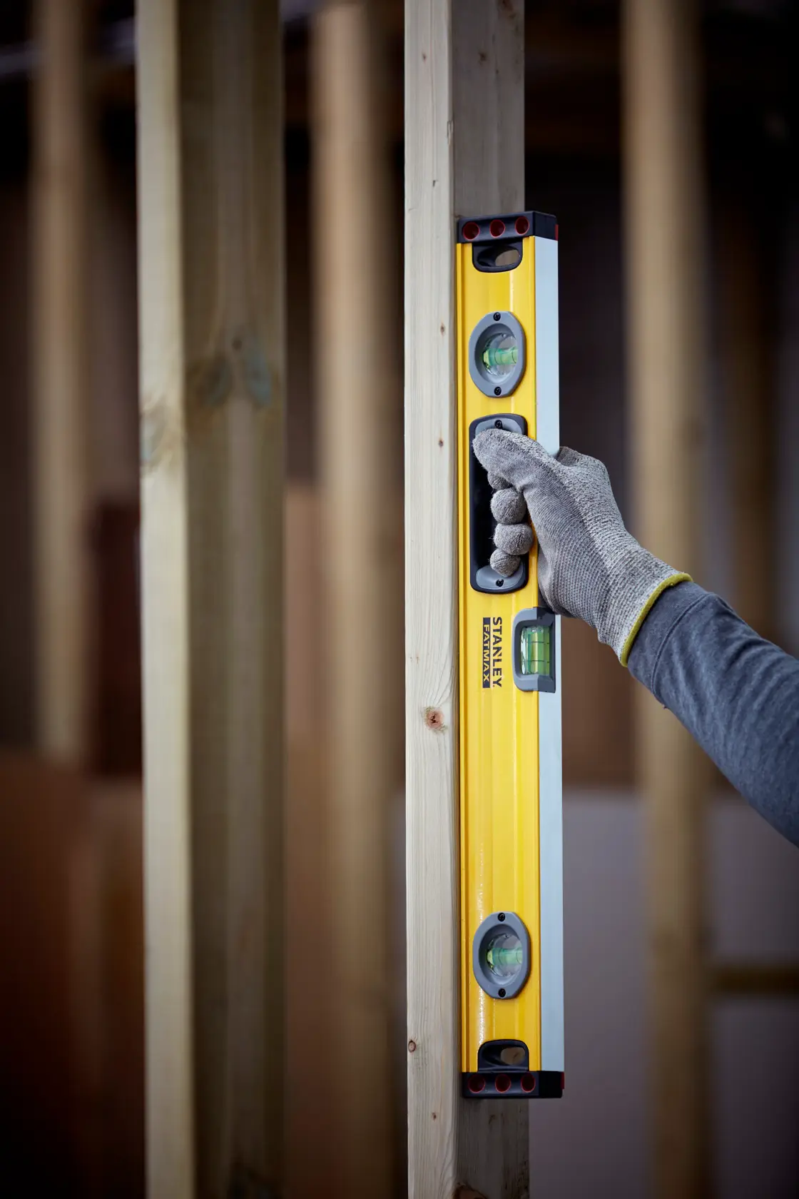 Photo of STANLEY 1-43-524 spirit level being used in vertical position on wood frame.