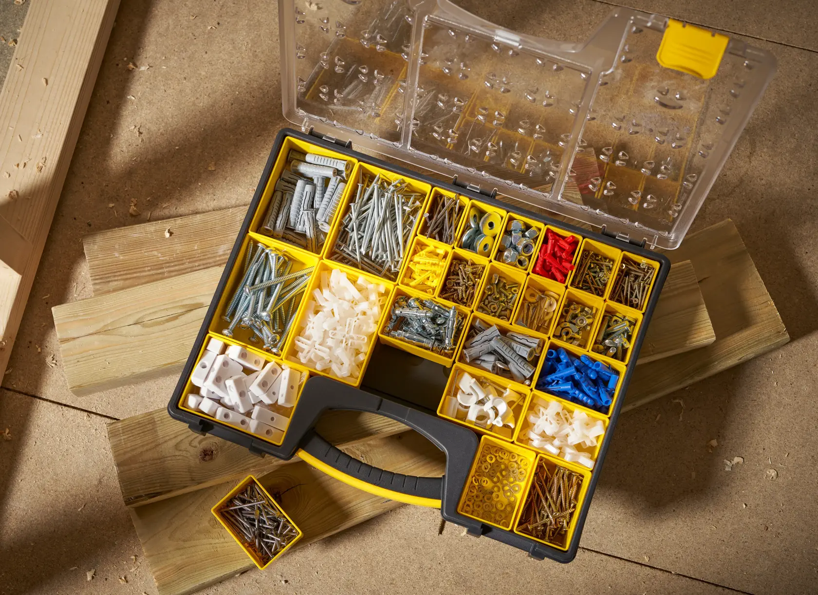 STANLEY 1-92-748 organizer box with yellow compartments, filled with assorted fasteners, photographed from above.