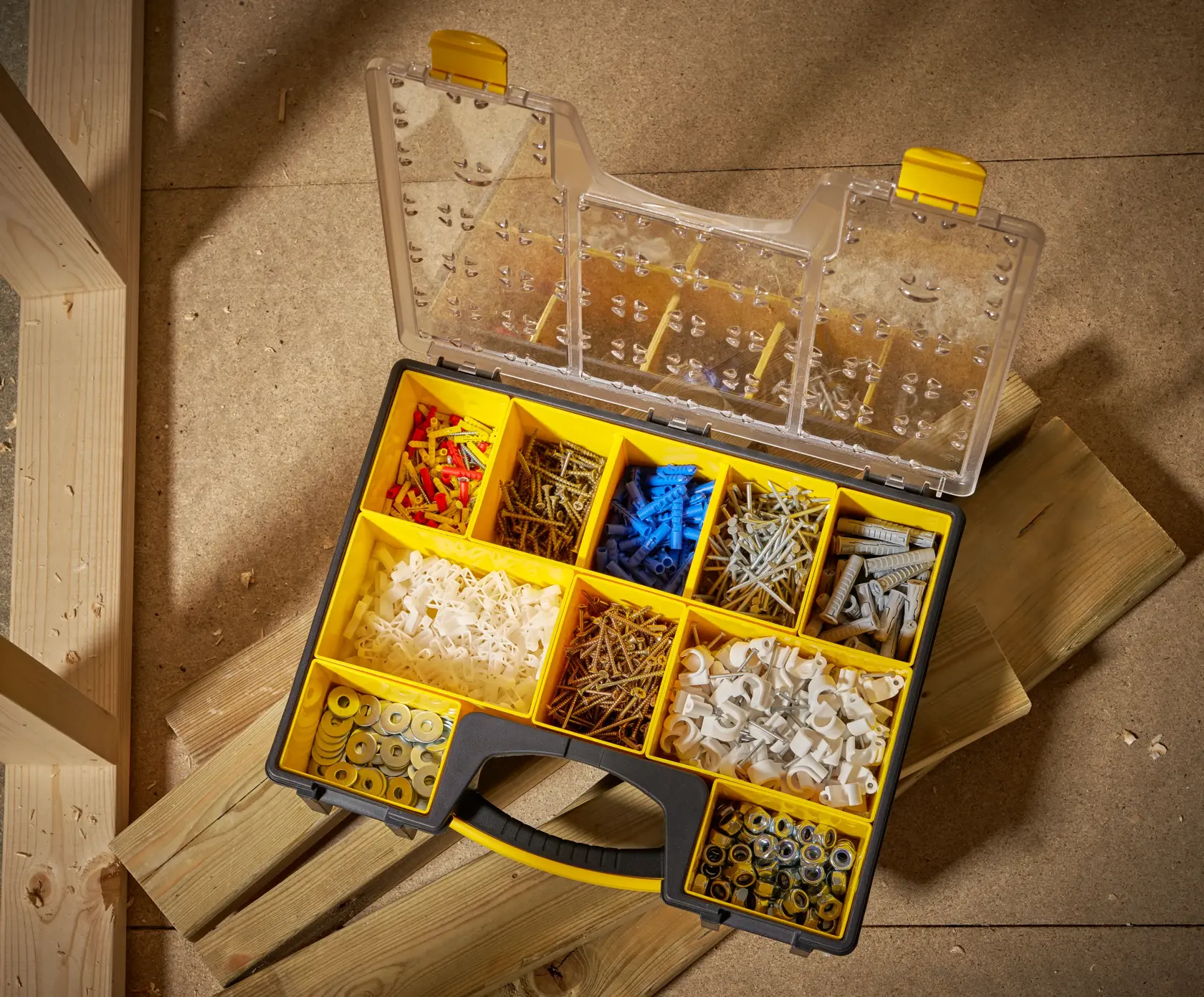 STANLEY 1-92-749 organizer box with assorted fasteners, photographed from above on wooden planks.