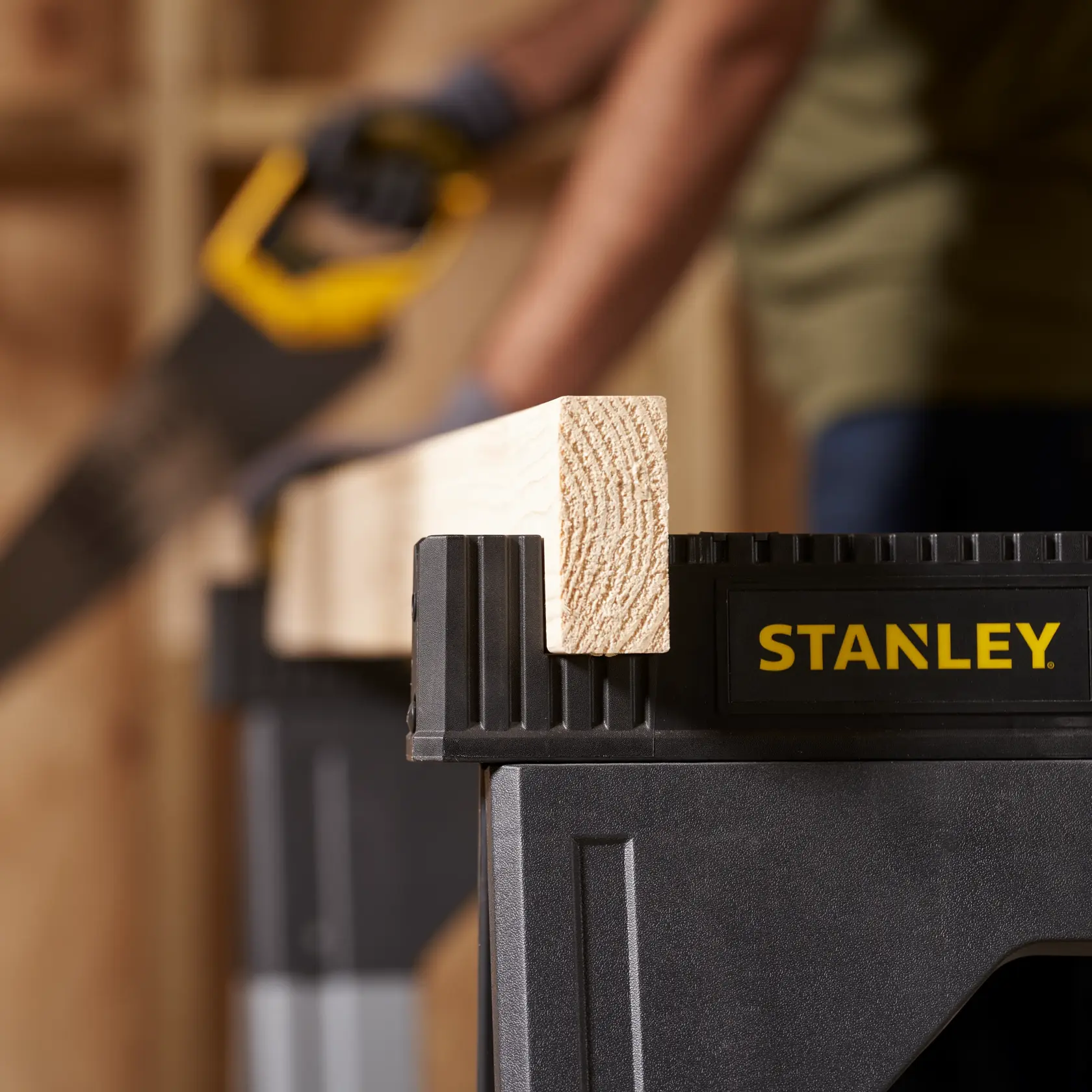 STANLEY 1-92-980 sawhorse holding a wooden beam in a workshop setting, photography close-up.