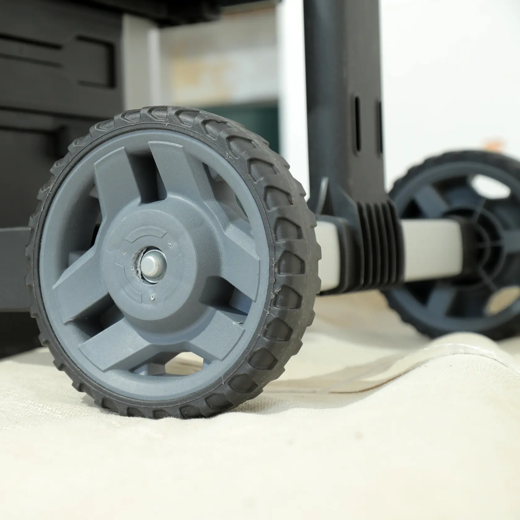STANLEY 1-95-622 photography of grey plastic wheel on tool storage cart, side angle view.