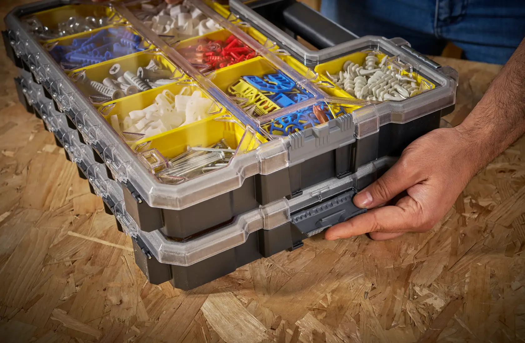 STANLEY 1-97-519 stackable organizer box with yellow compartments filled with assorted fasteners, close-up.
