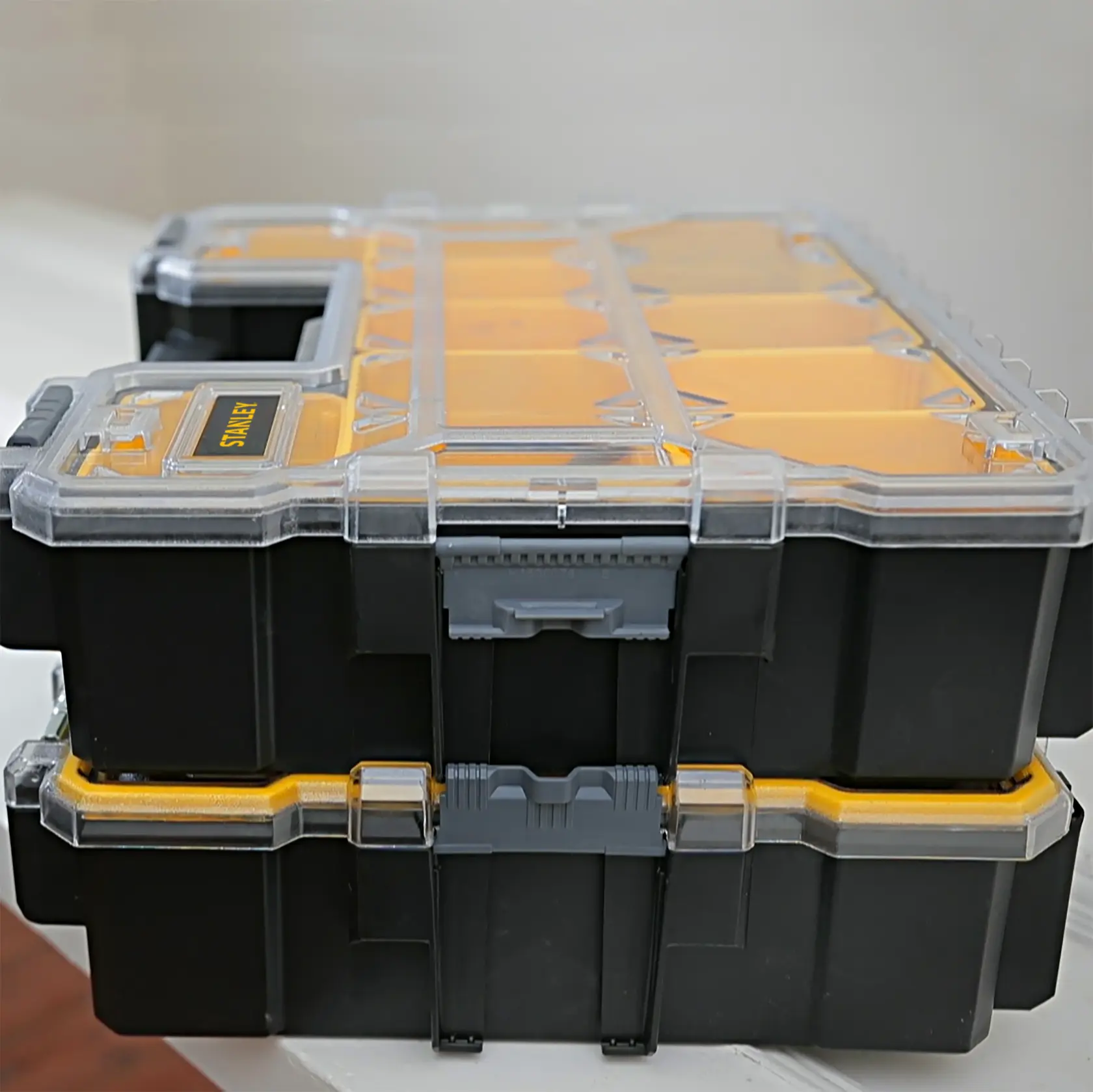 STANLEY 1-97-521 stackable plastic organizer with clear lid, black and yellow, shown from side angle.