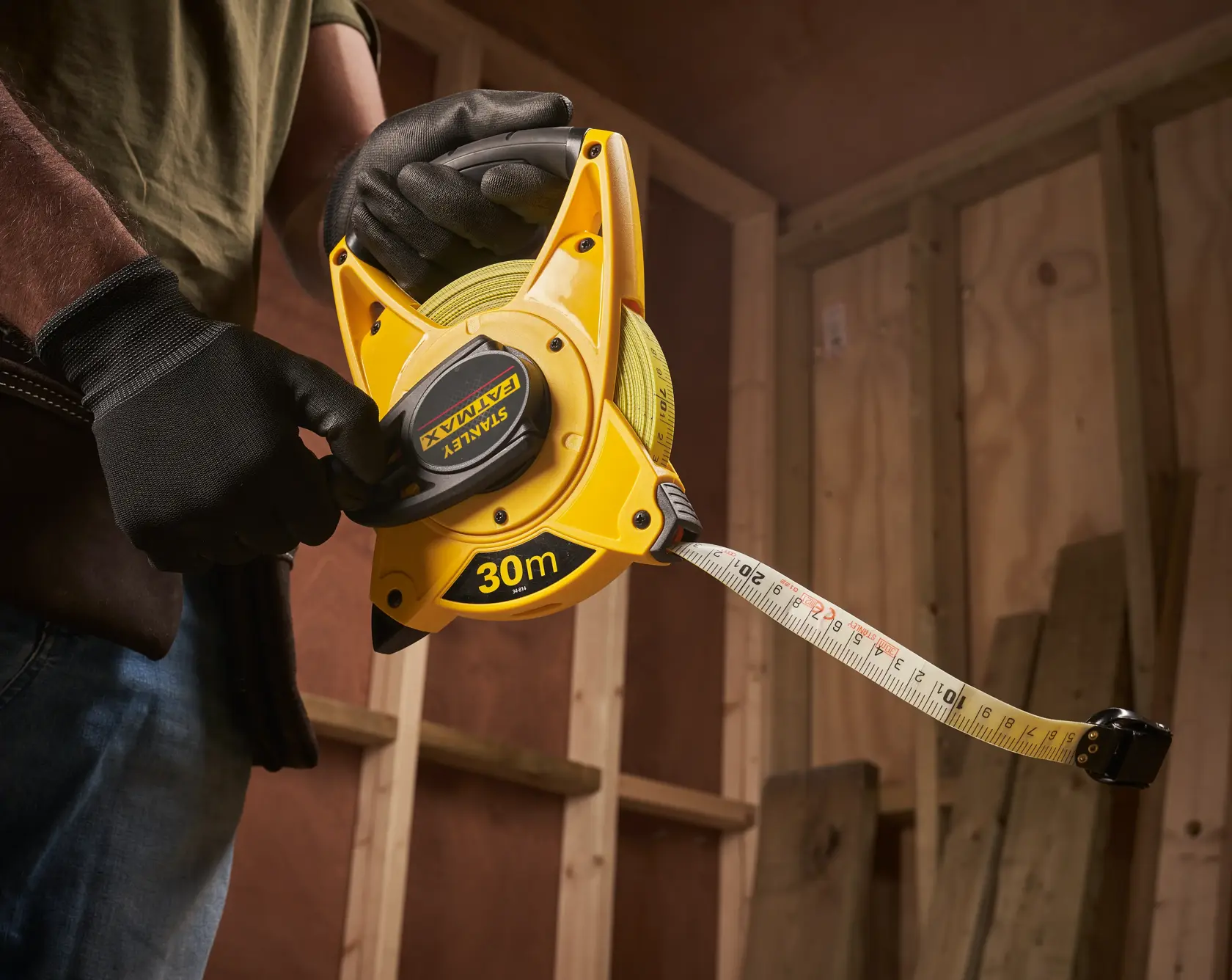 Photo of STANLEY 2-34-814 30m open reel tape measure in use at construction site.