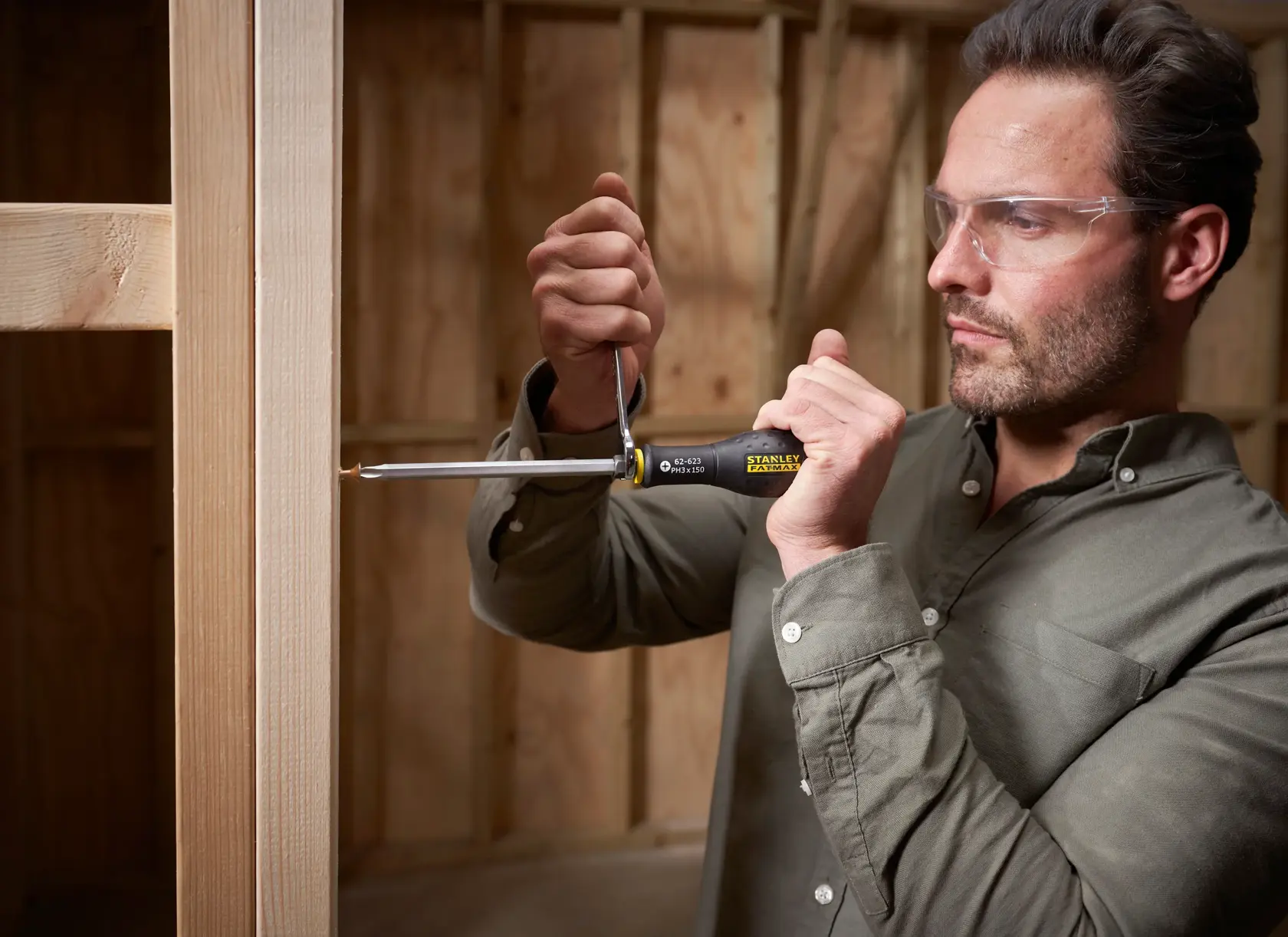 STANLEY FMHT0-62623 screwdriver in use for woodworking, close-up photo, product held in hand.