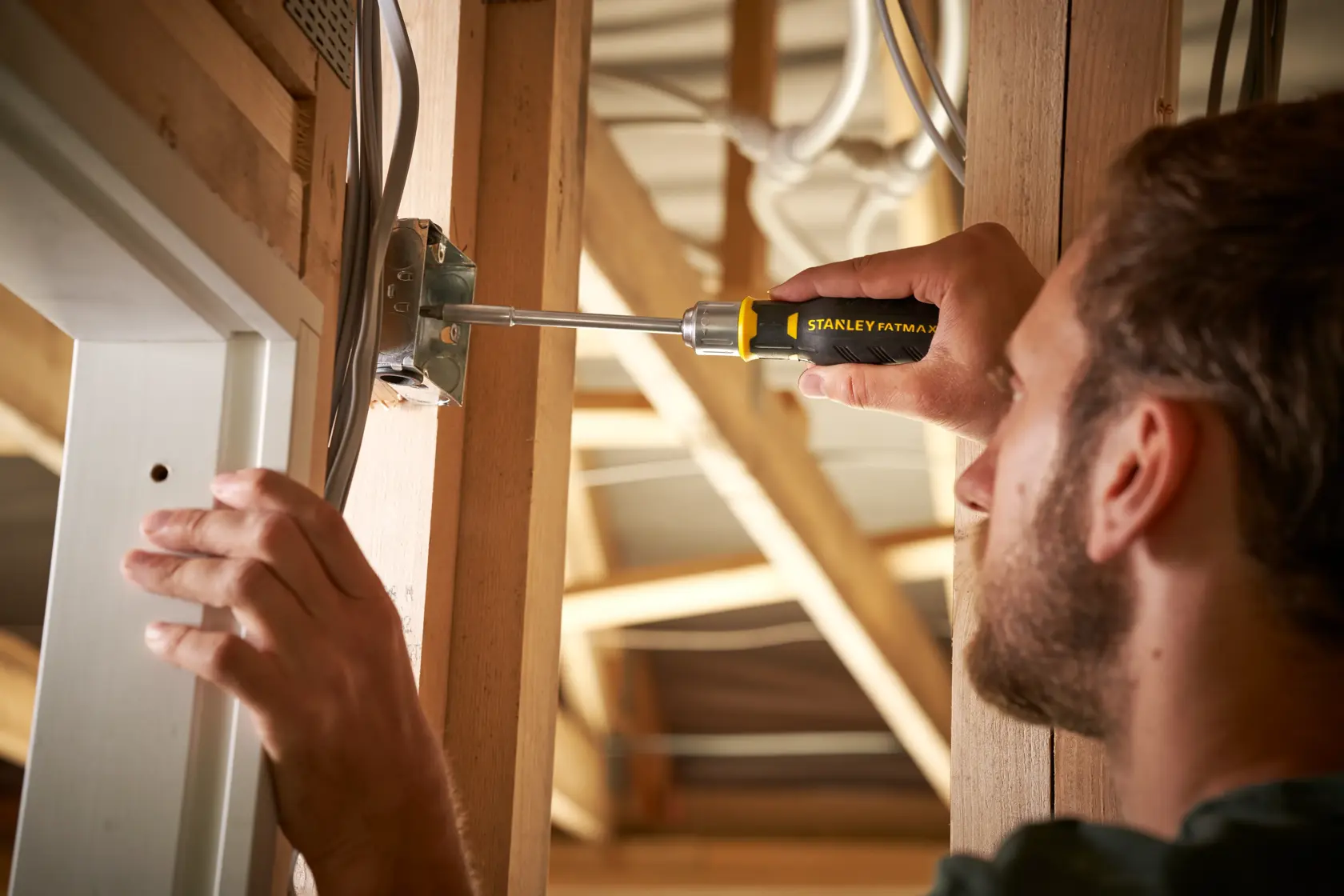 Photo of STANLEY FMHT0-62690 screwdriver used on electrical box in construction setting.