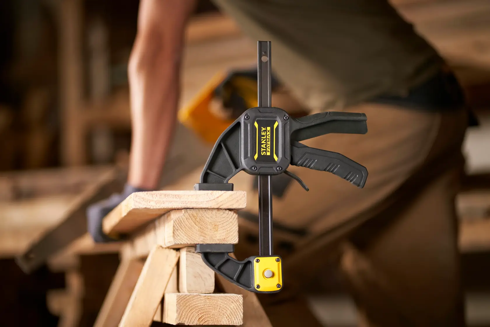 STANLEY FMHT0-83234 clamp holding wood in a workshop, close-up side view.