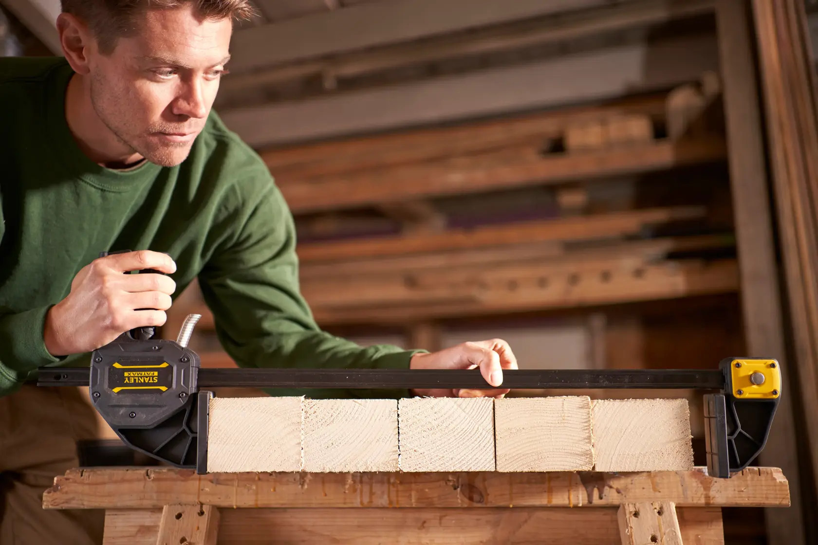 Stanley Fatmax trigger clamp for securing objects, shown with adjustable jaws and ergonomic handle.