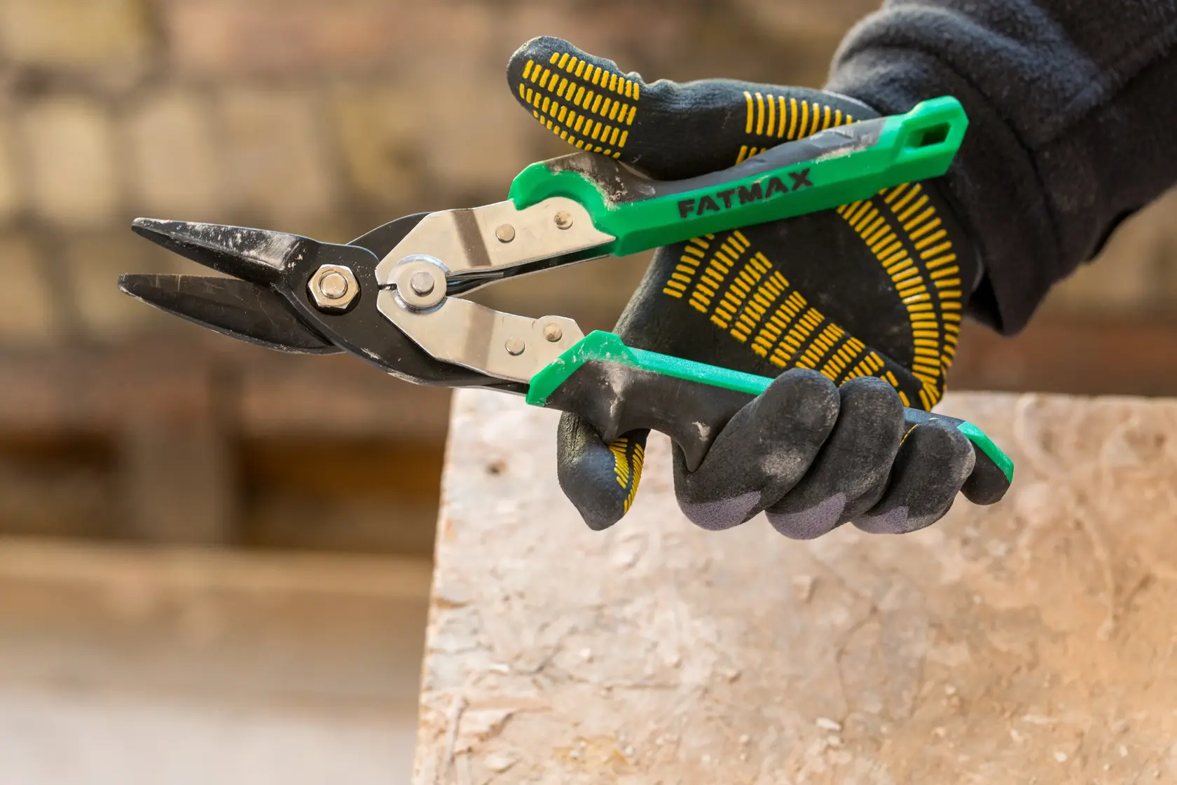 Stanley green and black aviation snips with ergonomic handles and metal blades on a white background.