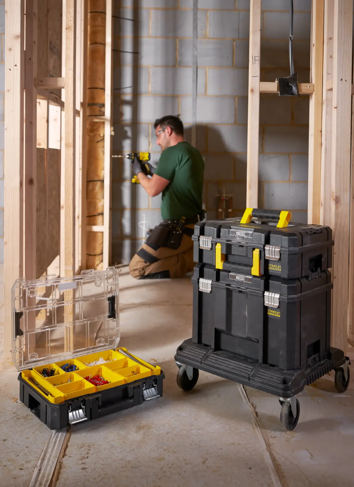 STANLEY FMST1-71966 mobile tool storage stack and organizer box with yellow handles on construction site.