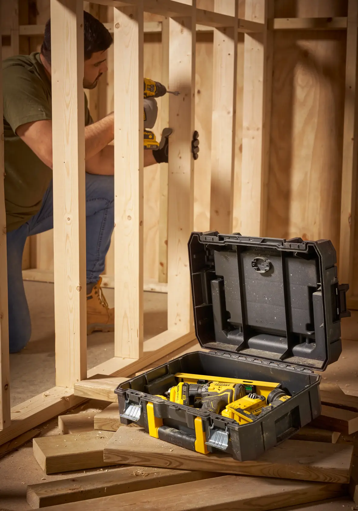 STANLEY FMST1-71967 tool case with yellow latches open on construction site with tools inside.
