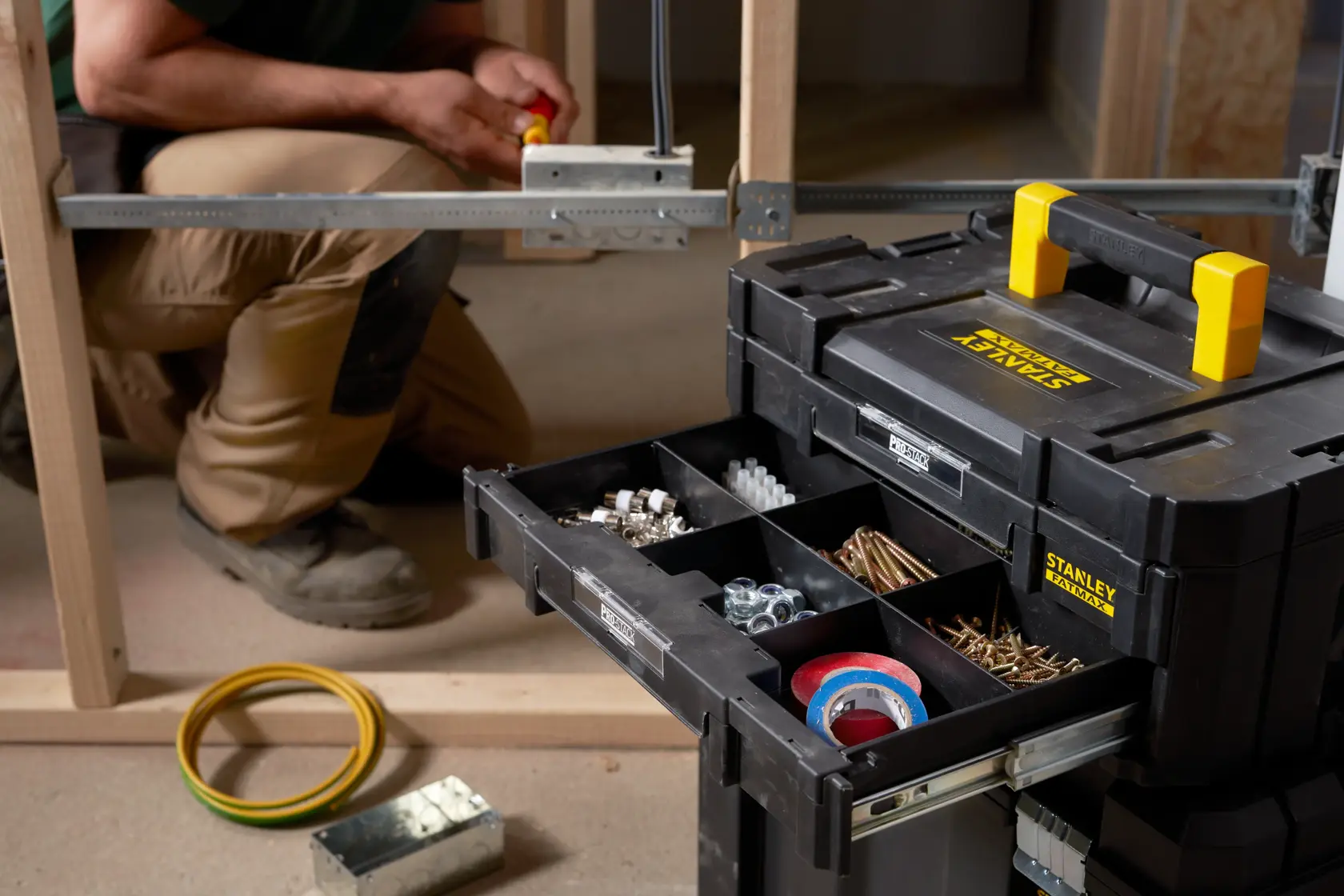 STANLEY FMST1-71969 tool organizer with open drawer showing compartments of fasteners and tape, front angle.