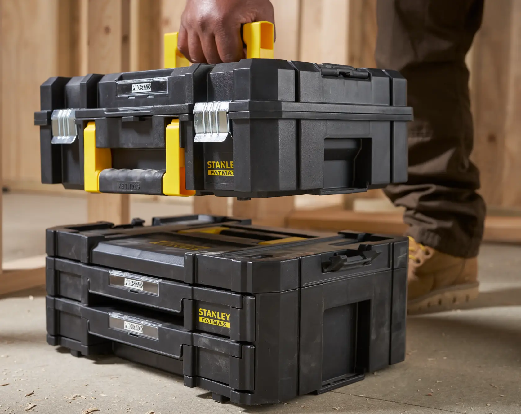 Photo of STANLEY FMST1-71981 toolboxes, black with yellow accents, stackable and with metal latches.