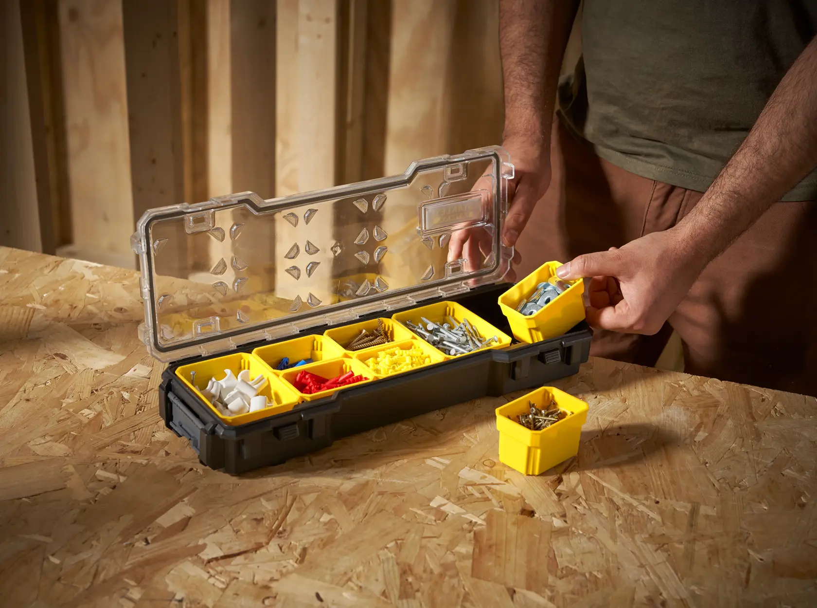 STANLEY FMST1-75781 organizer box with yellow removable bins for hardware, angled view on workbench.