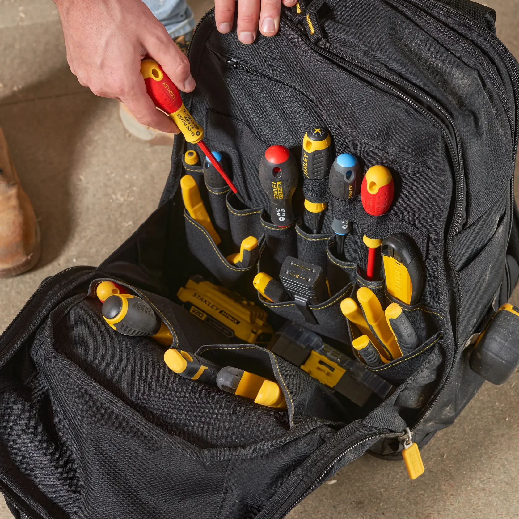 STANLEY FMST1-80144 tool backpack with organized hand tools in black and yellow, top view photo.