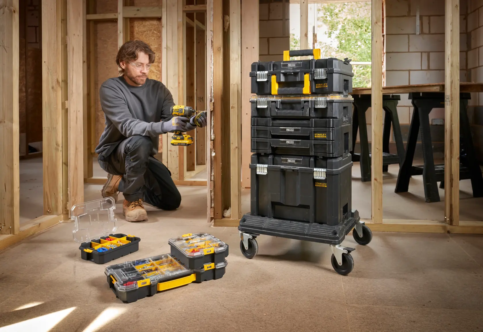 STANLEY FMST61150-1 stackable toolboxes on wheeled cart with open organizers, shown in construction site.