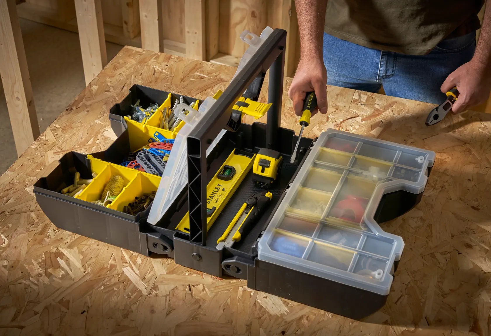 STANLEY STST1-71963 tool box open with compartments filled on workbench, photographed from above.
